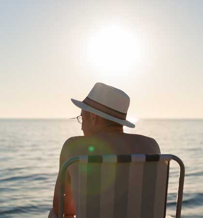 Person relaxing by the sea with no legal problems